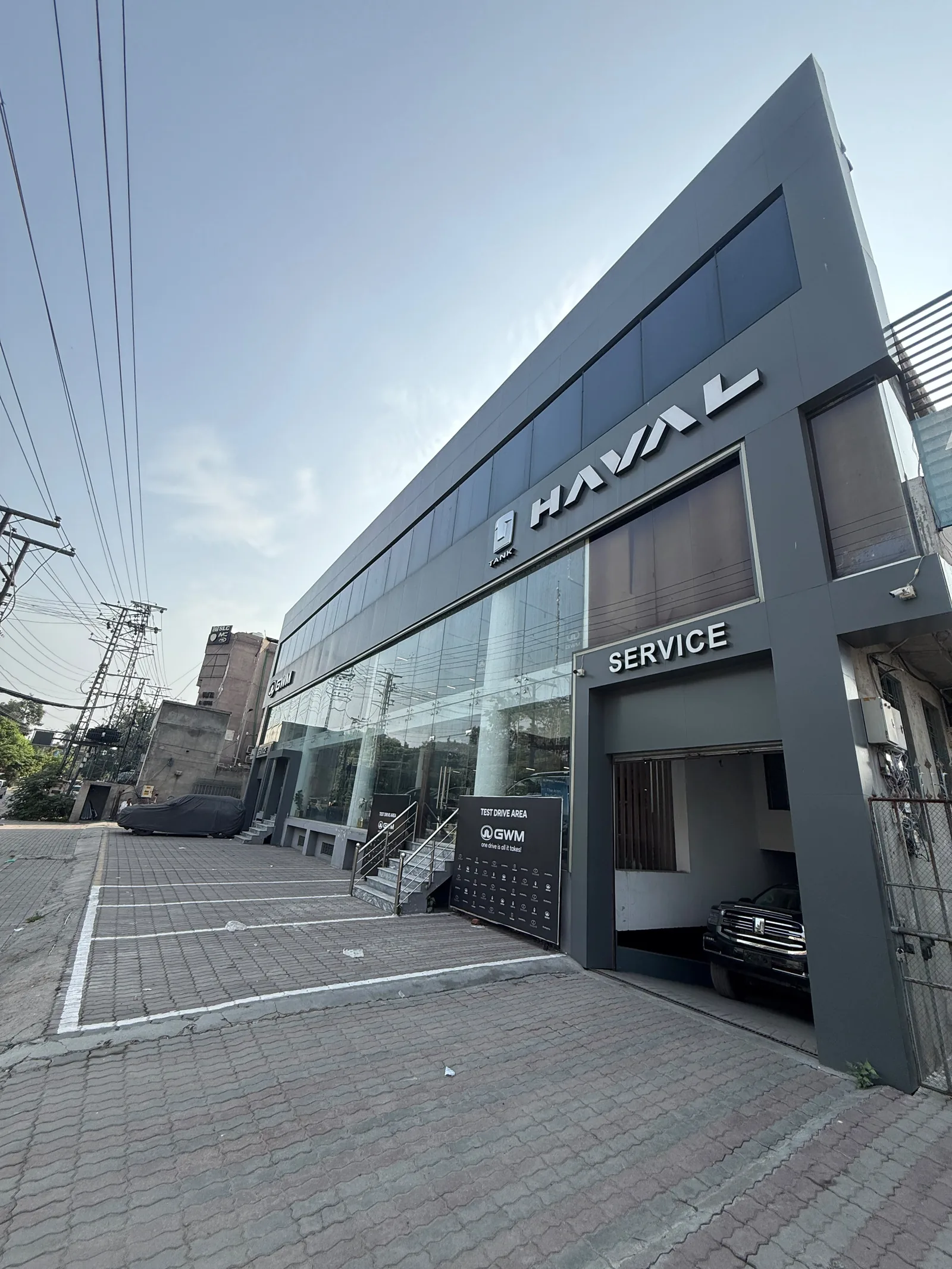 Queens Motors dealership facade on Queens Road, Lahore